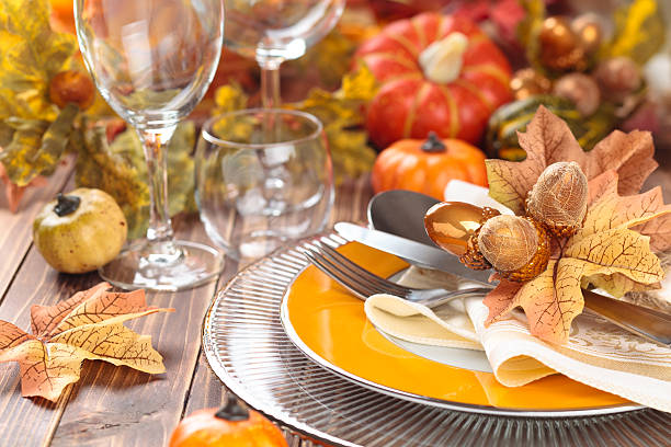 Thanksgiving dinner decoration. Autumn place setting with leaves, candles and pumpkins. centerpiece stock pictures, royalty-free photos & images