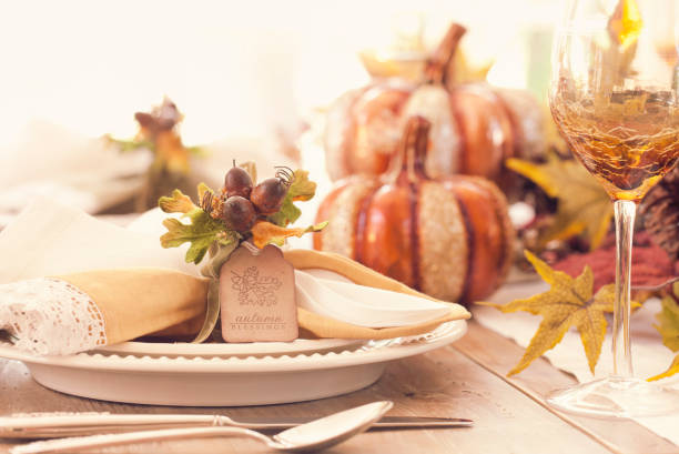 Thanksgiving holiday autumn place setting with place card Thanksgiving holiday autumn place setting with place card and greeting centerpiece stock pictures, royalty-free photos & images
