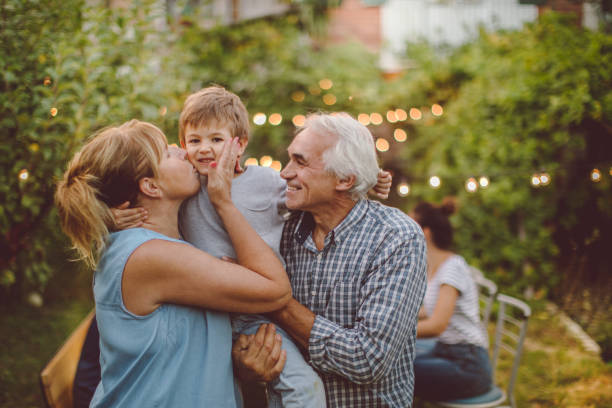 Thanksgiving with grandparents Photo of a little boy celebrating Thanksgiving with his grandparents on an outdoors dinner party yard grounds photos stock pictures, royalty-free photos & images