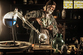 Medieval alchemist working in his laboratory