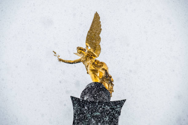 The Angel of Peace on the top of Friedensengel monument in Munich, Germany during the snow srorm stock photo