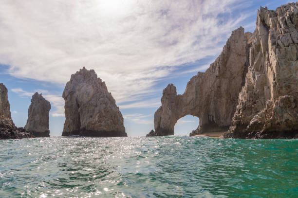 The Arch at Cabo San Lucas This is the world famous Arch rock formation in Cabo San Lucas, Mexico.  The Arch sits at the very tip of Baja California and is an obvious landmark for miles around.  The Arch is also a symbol of the Los Cabos region and creates a picturesque view at the meeting of the Pacific Ocean and Sea of Cortez. has san hawkins stock pictures, royalty-free photos & images