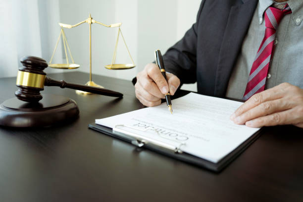 The attorney or judge  is drafting or reviewing client contract documents stock photo