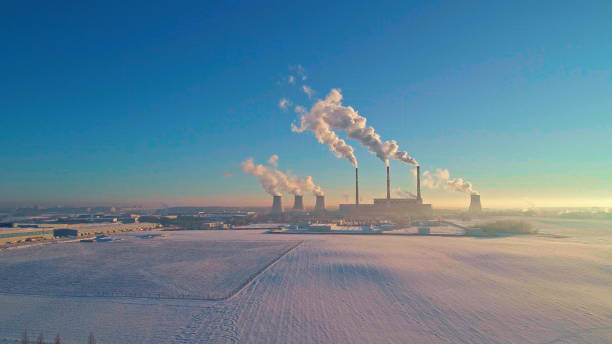 The bad ecology. The thermal power plant near by big city in the cold winter's day. Aerial drone photo The bad ecology. The thermal power plant near by big city in the cold winter's day. Sukharevo district, Minsk, Belarus, Eastern Europe. Aerial drone photo minsk stock pictures, royalty-free photos & images