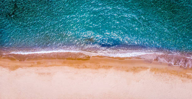 the beach with some waves from a drone stock photo