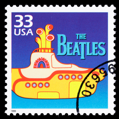 Sacramento, California, USA - March 19, 2011: A 1999 USA postage stamp with an illustration of the Yellow Submarine, the 1968 animated movie featuring songs by The Beatles. The Beatles' logo is also shown, which is a registered trademark of Apple Corps Limited; Yellow Submarine is a registered trademark of Subafilms Limited.