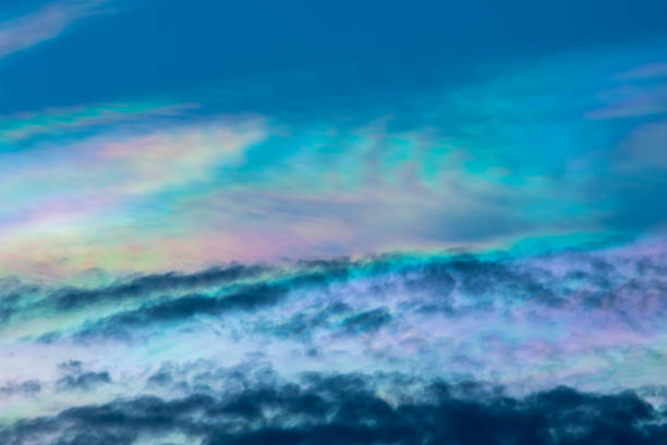 The beauty of the rainbow clouds Above the black clouds in the evening. stock photo