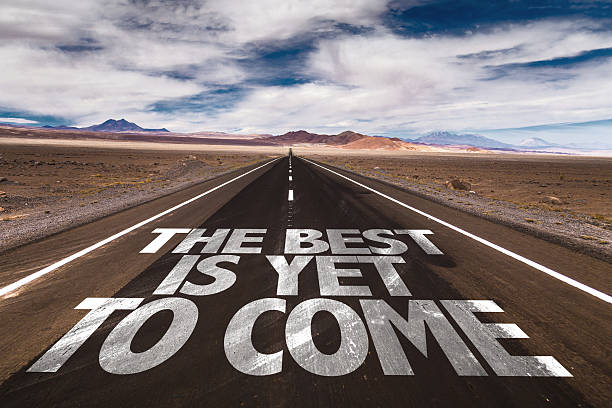 The Best is Yet to Come written on desert road stock photo