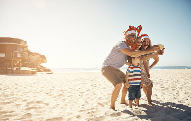 The best thing about memories…is making them Shot of a family taking a selfie at the beach on Christmas dayhttp://195.154.178.81/DATA/i_collage/pu/shoots/806441.jpg australia photos stock pictures, royalty-free photos & images