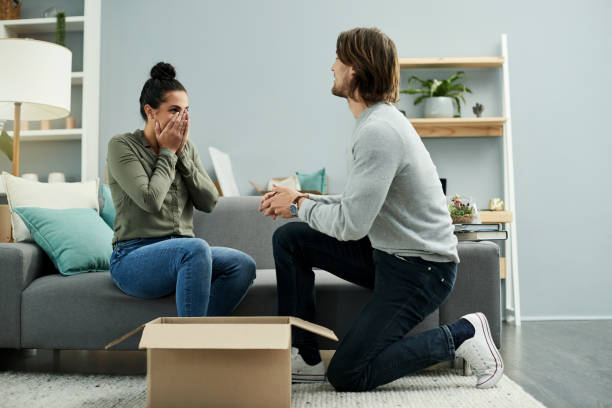 The best time for new beginnings is now Cropped shot of a handsome young man proposing to his beautiful young girlfriend on their moving day fiancé stock pictures, royalty-free photos & images