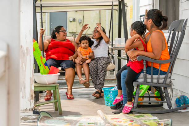 The big happy Latino Mexican-American family resting at the porch of his house The big happy Latino Mexican-American family resting at the sunny summer weekend on the porch of his house in Pennsylvania, USA hot mexican girls stock pictures, royalty-free photos & images