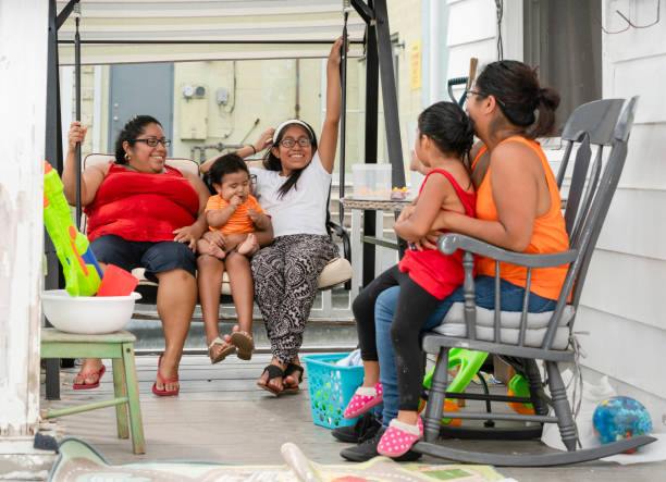 The big happy Latino Mexican-American family resting at the porch of his house The big happy Latino Mexican-American family resting at the sunny summer weekend on the porch of his house in Pennsylvania, USA hot mexican girls stock pictures, royalty-free photos & images