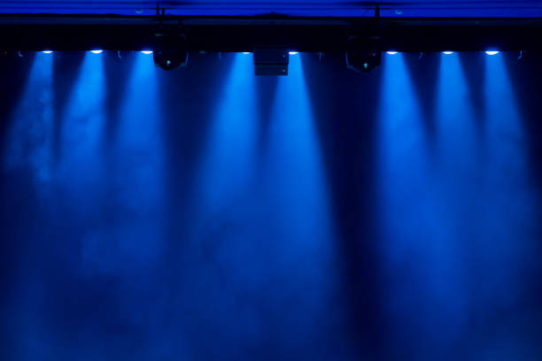 The blue light from the spotlights through the smoke in the theatre during the performance. Lighting equipment. The blue light from the spotlights through the smoke in the theatre during the performance. Lighting equipment. staging light stock pictures, royalty-free photos & images