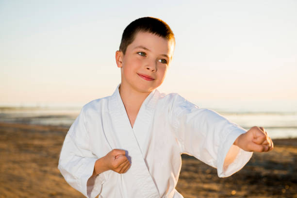 The boy in a kimono on the beach The boy in a kimono on the beach military schools stock pictures, royalty-free photos & images