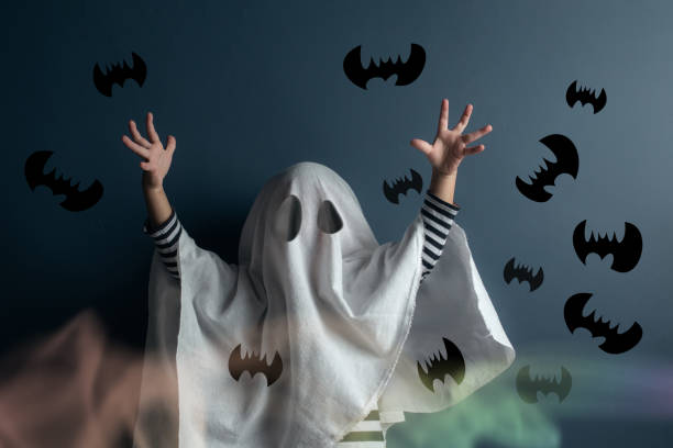 The boy in ghost clothes released many bats from the veil.  ghost boy stock pictures, royalty-free photos & images