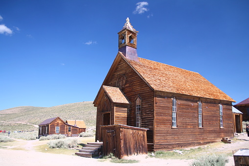 The brown abandoned ghost church of Bodie with the blue sky on the background in California