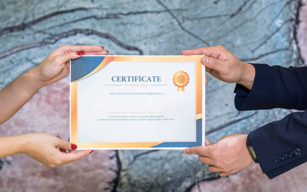 The business executive was satisfied with the work of the female employee and gave her a certificate of excellence. stock photo