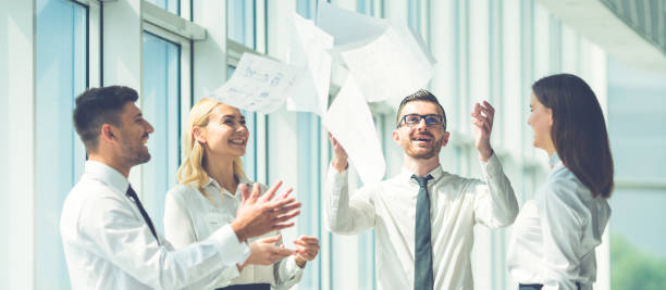 The business people throw papers near the window stock photo