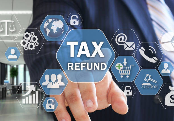 The businessman chooses TAX REFUND on the virtual screen in social network connection. stock photo
