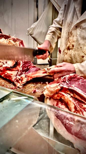 CHOPS - the butcher chopping raw meat at the mercato centrale firenze. stock photo