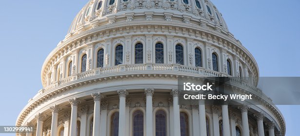 istock The Capitol Building rotunda in Washington, D.C. with a bright blue sky. 1302999941