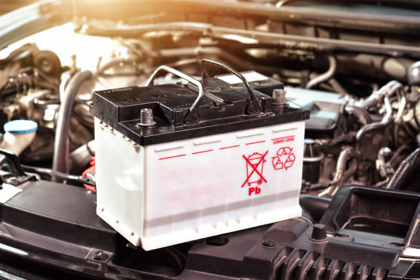 The car battery of the automobile electrical system in the engine compartment stock photo