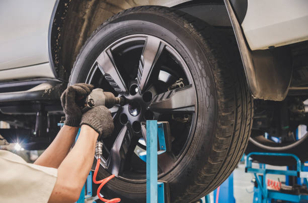The car mechanic is changing the tire. stock photo