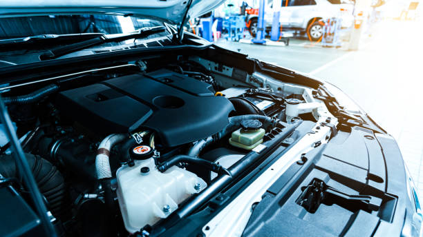 The car opened the hood of the car in the auto repair center to check the engine. stock photo