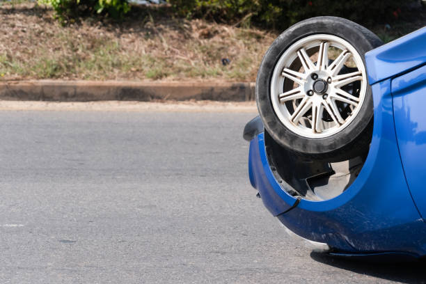 The car overturned due to the driver in a hurry. or driving while intoxicated at high speed When there is an accident on the road, the driver should have car insurance. stock photo