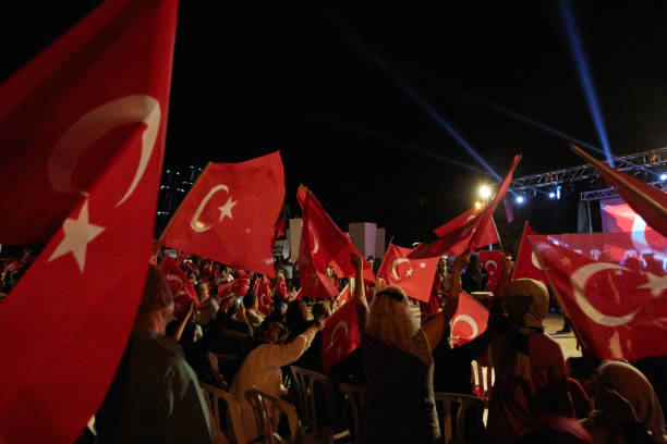 The celebration of democracy in Turkey Izmir - Turkey - July 15, 2018: The celebration of democracy in Turkey. There are Turkish flags in the hands of people and in Fethiye Cumhuriyet Square. Democracy and National Unity Day, celebrated every year on July 15 in Turkey july stock pictures, royalty-free photos & images