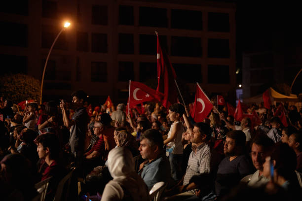 The celebration of democracy in Turkey Izmir - Turkey - July 15, 2018: The celebration of democracy in Turkey. There are Turkish flags in the hands of people and in Fethiye Cumhuriyet Square. Democracy and National Unity Day, celebrated every year on July 15 in Turkey july stock pictures, royalty-free photos & images
