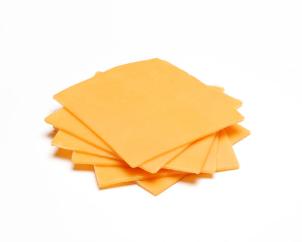 The cheddar cheese Cheddar cheese slices on white background. cheddar cheese stock pictures, royalty-free photos & images