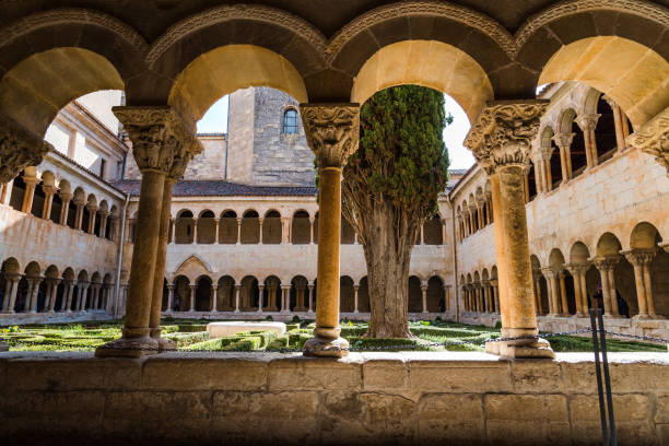 The cloister of Santo Domingo de Silos Abbey Santo Domingo de Silos, Spain - April 16, 2019: The cloister of Santo Domingo de Silos Abbey. It is a Benedictine monastery and a masterpiece of Romanesque art abbey monastery stock pictures, royalty-free photos & images