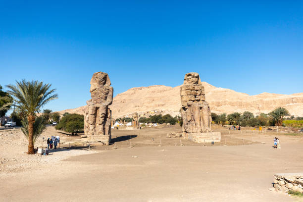 The Colossi of Memnon in Luxor, Egypt. Two massive stone statues of the Pharaoh Amenhotep III stock photo
