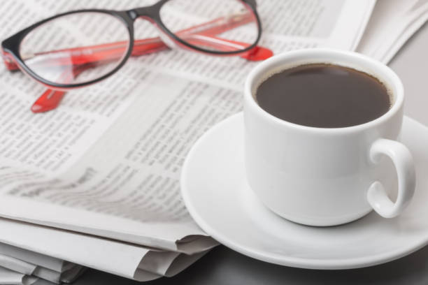 The concept of news. Newspaper on the table, glasses. Coffee break. stock photo