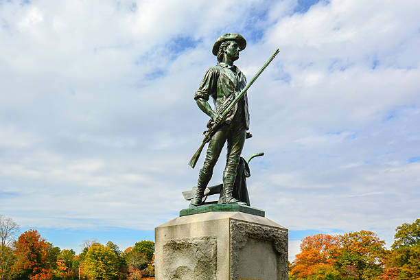 The Concord Minute Man by the Old North Bridge - Concord, MA The Concord Minute Man of 1775 by Daniel Chester French, erected in 1875 in Concord, Massachusetts, depicting a typical minuteman. militia stock pictures, royalty-free photos & images