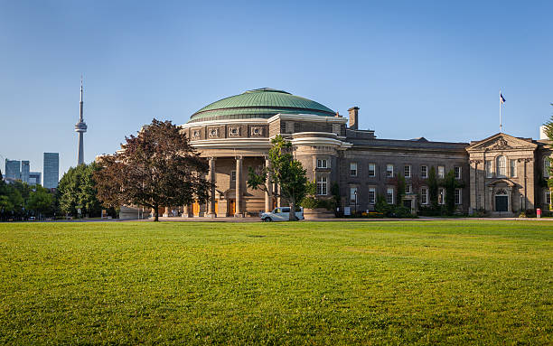 The Convocation Hall of the University of Toronto The Convocation Hall of the University of Toronto; CN Tower in distance university of toronto stock pictures, royalty-free photos & images