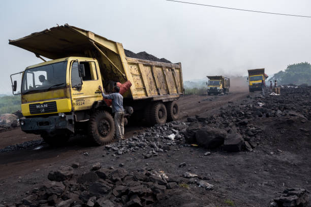 The Curse Of Coal Coal is to be transported by trucks in Jharia, Dhanbad, India. scavenging stock pictures, royalty-free photos & images