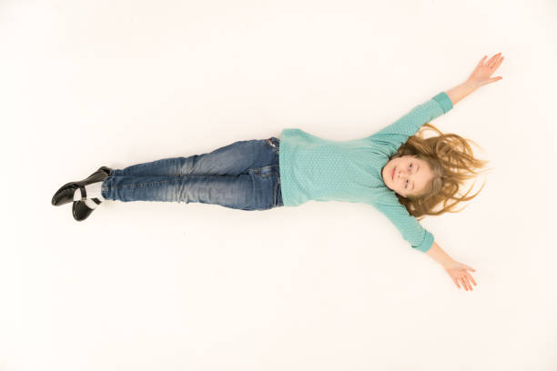 The cute girl lay on the floor. View from above stock photo