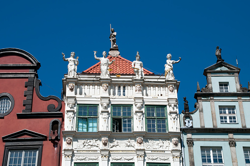 Decorative attic of the Golden Tenement House with statues of the four cardinal virtues