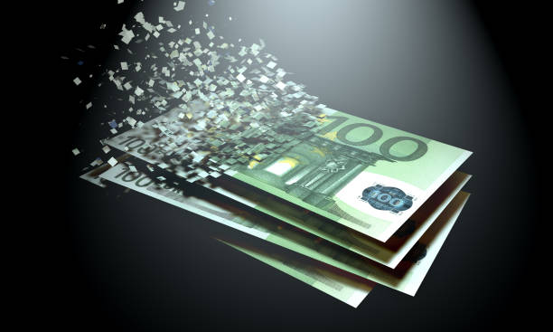 The dematerialization of money, euros are dematerialized on a black background. stock photo