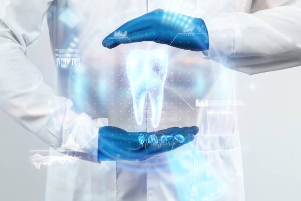 The dentist looks at the hologram of the tooth, checks the test result on the virtual interface and analyzes the data. Concept for innovative technologies, medicine of the future, tooth snapshot stock photo