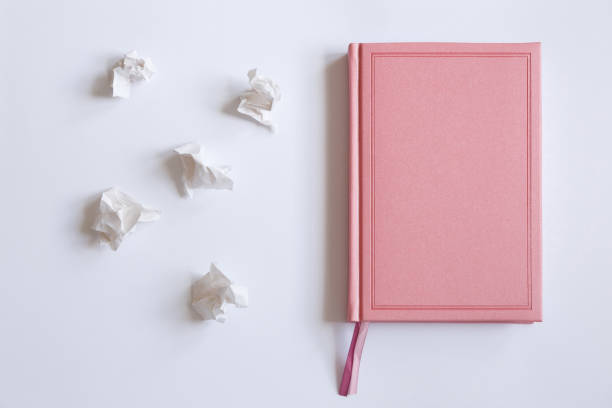 The diary on a white background and crumpled pieces of paper Pink diary on a white background and crumpled pieces of paper, flat lay. Mistakes in the letter romance book cover stock pictures, royalty-free photos & images