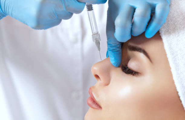 The doctor cosmetologist makes prick in the nose to correct the hump of a beautiful woman in a beauty salon. The doctor cosmetologist makes prick in the nose to correct the hump of a beautiful woman in a beauty salon. Cosmetology skin care. nose stock pictures, royalty-free photos & images