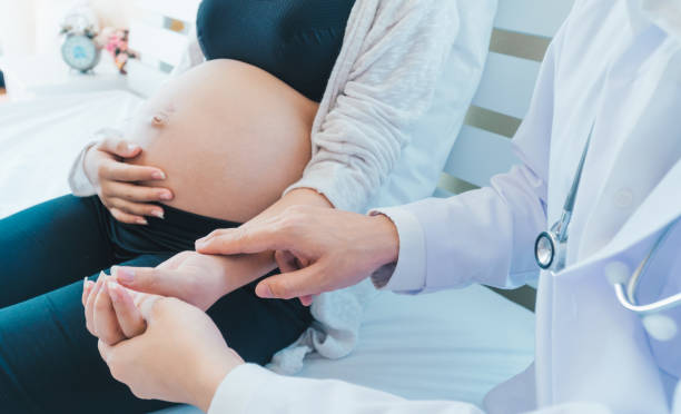 The doctor is diagnosing pregnant women. stock photo
