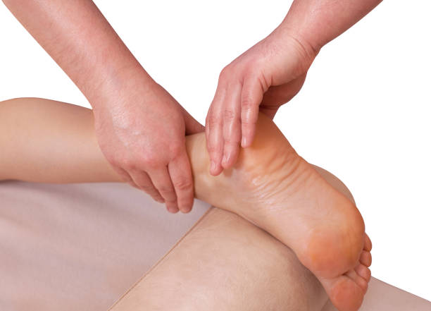 The doctor-podiatrist does an examination and massage of the patient's foot The doctor-podiatrist does an examination and massage of the patient's foot in the clinic. plantar fasciitis stock pictures, royalty-free photos & images