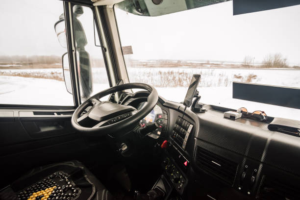 The driver's seat in the cab of the truck stock photo