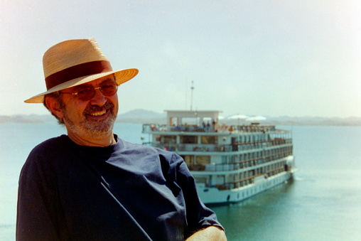 Upper Egypt - May 1989. A tourist wearing a straw hat on the sun deck of a Nile cruise ship. The image were scanned from old negative.