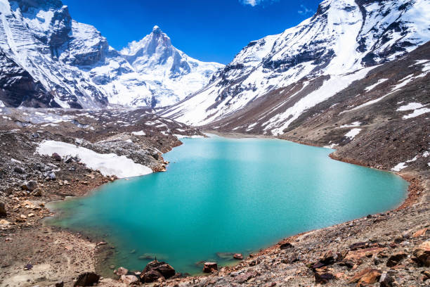 The emerald green fresh water glacier lake of Kedartal Situated at the base of MountThalay Sagar in the upper Garhwal reaches of Himalayas. himalayas stock pictures, royalty-free photos & images