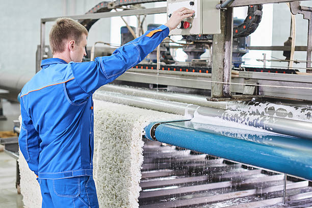 The employee works on the machine for carpet cleaning stock photo